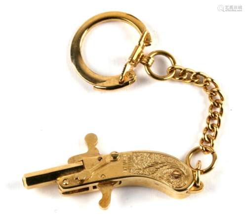 A vintage German miniature percussion cap 2mm pistol by Maus, with associated keyring. 4cm.