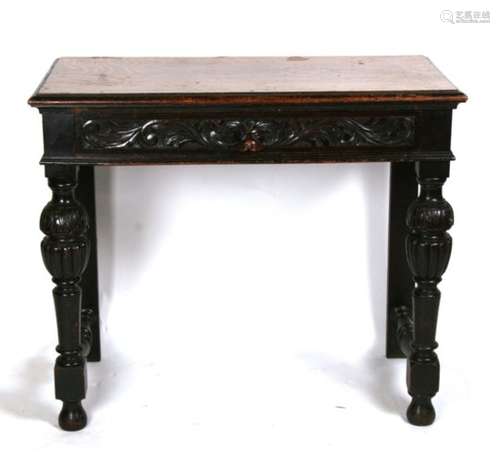 A Victorian carved oak side table with single frieze drawer with lion mask handle, on turned front