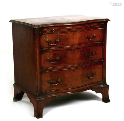 A serpentine fronted mahogany bachelor's chest, the brushing slide above three long graduated