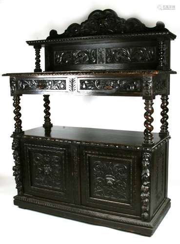 A Victorian carved oak buffet with lion mask carved crest rail above two frieze drawers on barley