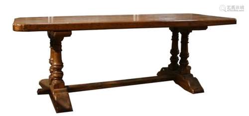 A solid oak refectory table on twin turned supports, 92 by 228cms (36 by 90ins)