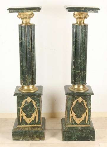 Two large decorative black marble columns in Empire