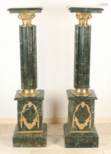 Two large decorative black marble columns in Empire