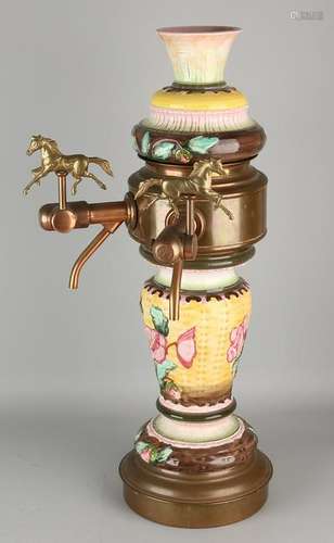 Old Majolica beer tap with brass horses and cranes.