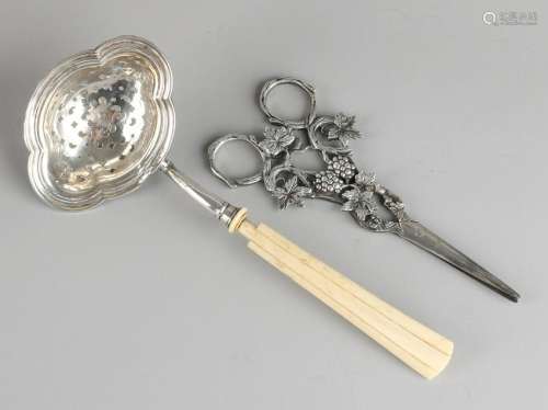 Silver dispensing spoon, 833/000 and grapes scissors,