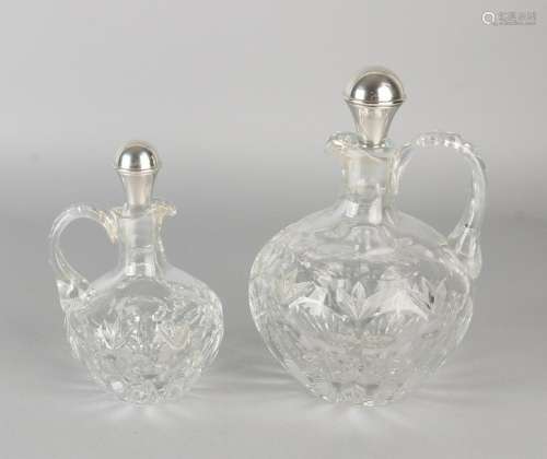 Two cut crystal oorkaraffen equipped with various