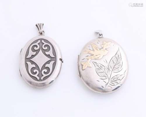 Two silver medallions, oval shapes, decorated with a