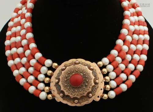 Necklace with red coral and pearls on an antique yellow