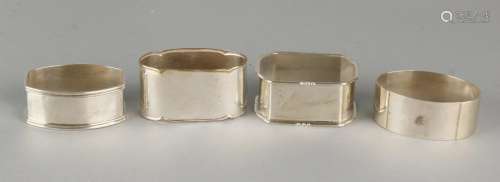 Lot four napkin rings, three silver, 835/000, and