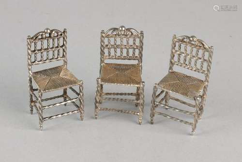 Three silver miniatures of chairs with carved reed