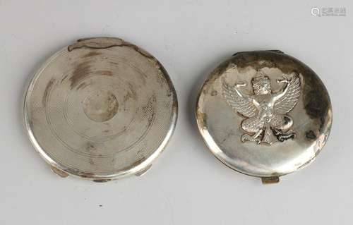 Two silver powder compacts, round model with spiral