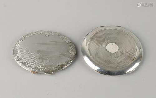 Two silver powder boxes, 835/000, a round model with