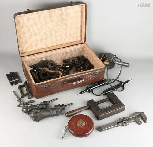 Suitcase full of antiques. Include: Door knockers, door