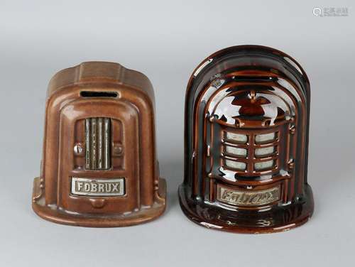 Two antique enamelled cast-iron piggy banks. Fobrux.