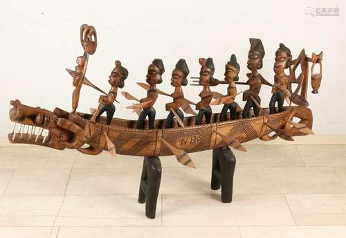 Large African wood figures put boat with legs and