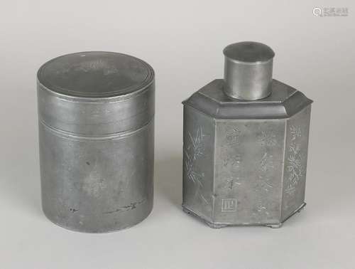 Two antique pewter tea caddies with Chinese characters.