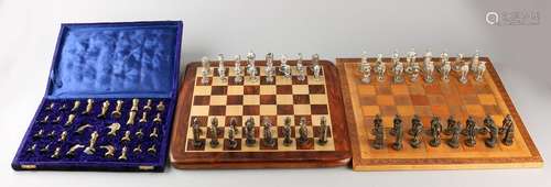 Three play chess with chess pieces of bronze. One time