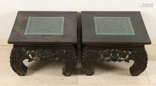 Two Oriental carved teak side tables. 20th century.