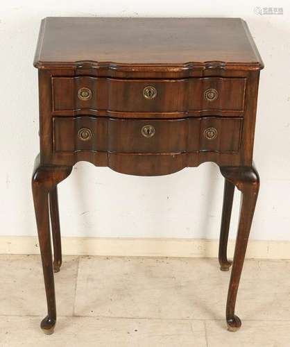 Antique walnut curved chest of drawers on tall legs.