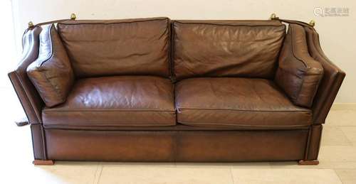 Brown leather couch, also called castle bank. With