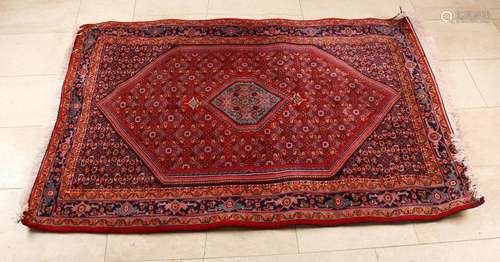 Red Persian rug with floral decor. Recently cleaned.