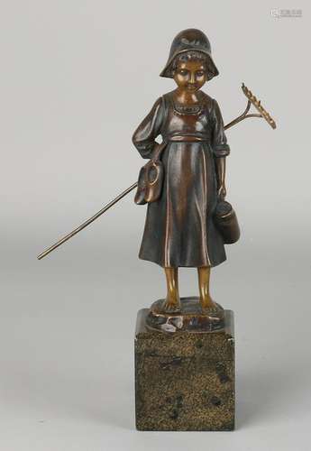 Antique bronze statuette. Circa 1910. Farmers girl with