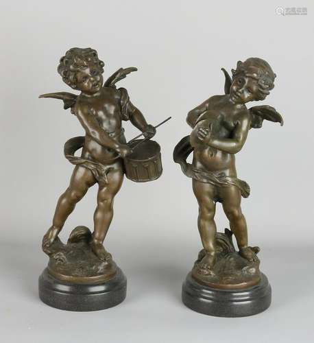 Two bronze statues putti playing music. To L. F.