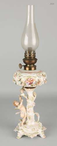 Antique porcelain kerosene lamp with putti and flowers.