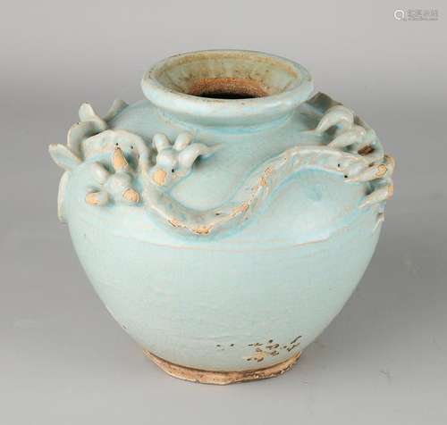 Antique Chinese celadon vase with dragon around.