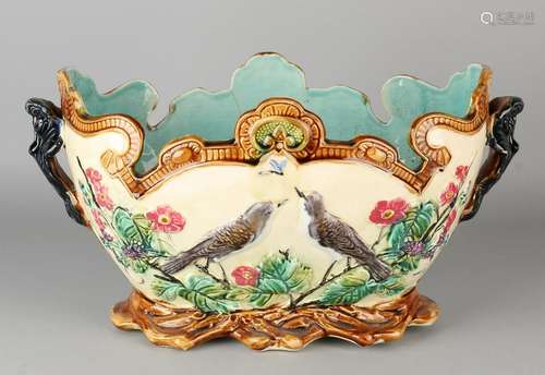 Antique majolica jardiniere with floral / bird decor.