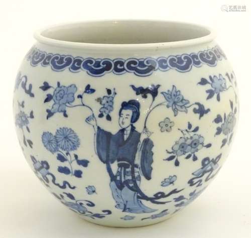 A blue and white Oriental jardiniere, decorated with figures in traditional dress and flowers.