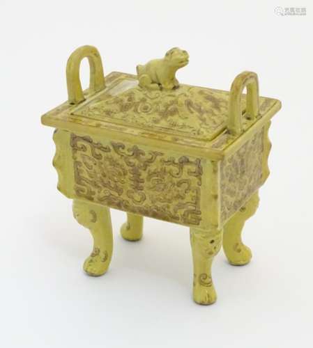 A Chinese rectangular censer with a yellow ground, raised on 4 paw footed legs,