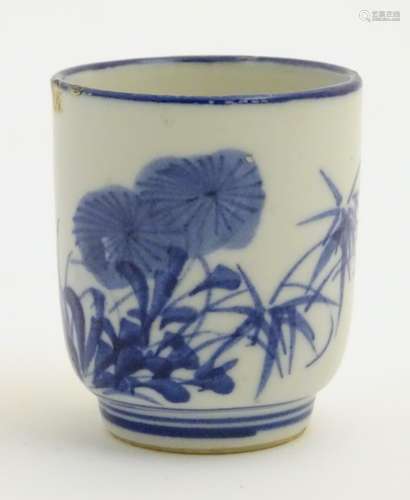 A Japanese blue and white pot with hand painted floral and foliate decoration.