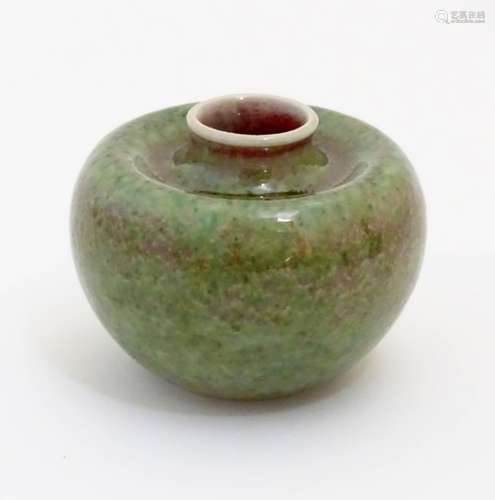 A small Chinese brush washer of circular form in a mottled green and pink glaze.