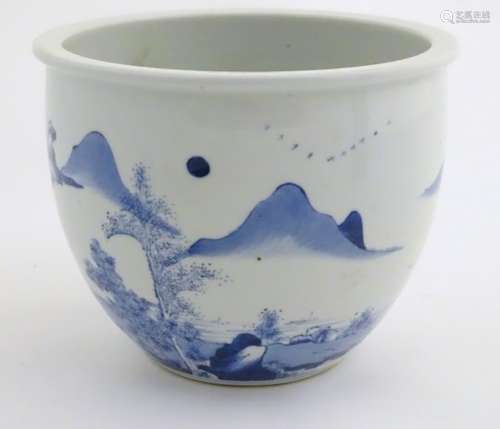 A Chinese blue and white jardiniere decorated with a mountainous landscape scene with figures,