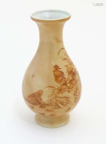 A Chinese baluster vase with a buff coloured ground decorated with a hen,