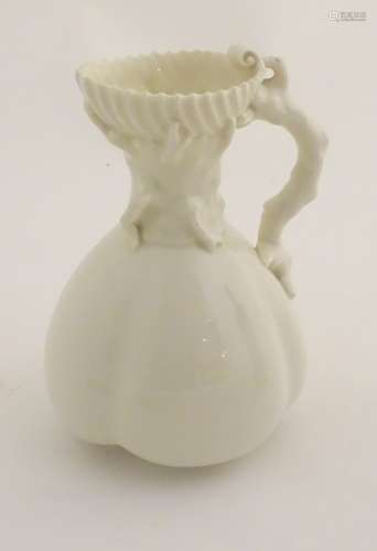 A 19thC Royal Worcester blanc de chine jug with a bulbous body, the handle formed as stylised coral,