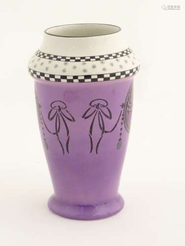 A Shelley vase with a purple ground, decorated with Art Nouveau flowers and pinwheels.