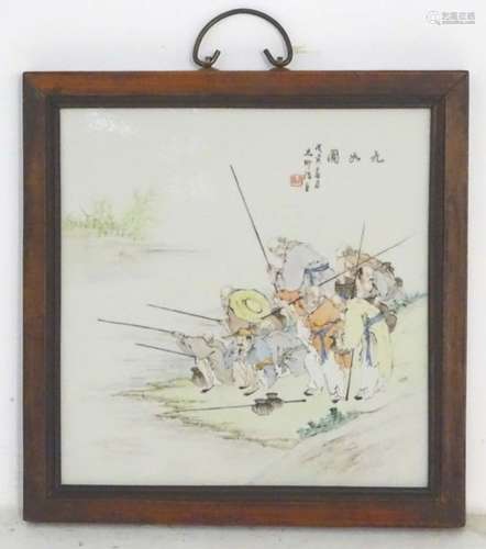 A 20thC Chinese wooden wall hanging with a porcelain panel depicting elders fishing on the bank of