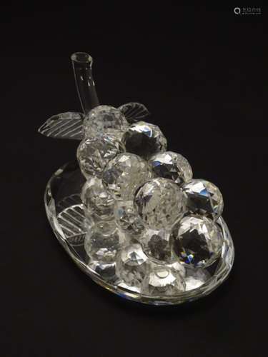 A Swarovski-style crystal table decoration in the form of a bunch of grapes, with mirrored base,