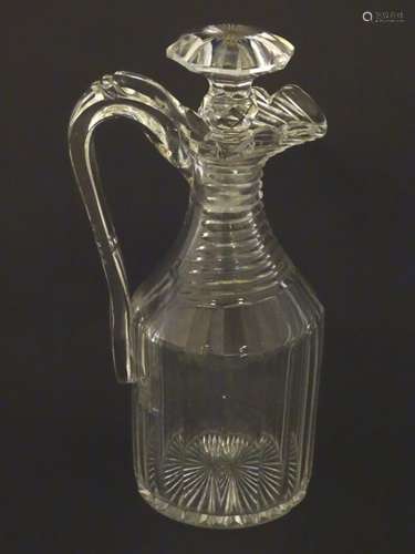 A 19thC Irish cut glass decanter and stopper, having a panelled body with ribbed neck,