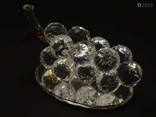 A Swarovski-style crystal table decoration in the form of bunch of grapes with mirrored base,