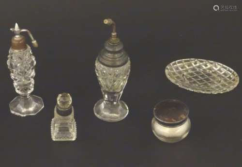 Assorted cut glass scent bottles, together with a glass pot and pin dish, some with silver mounts.