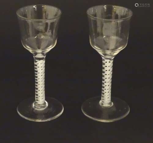 Two 18thC cordial glasses with double air twist stems and spreading foot.
