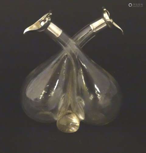 Oil / vinegar bottles of conjoined form with silver mounts and hinged spherical stoppers.