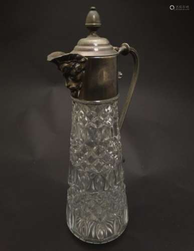 A glass claret jug with silver plate handle and mounts 11 1/2
