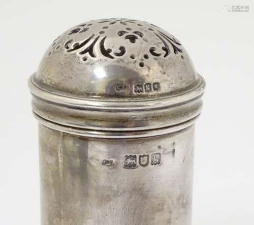 A silver sugar shaker / caster / mufineer of cylindrical form with domed top.