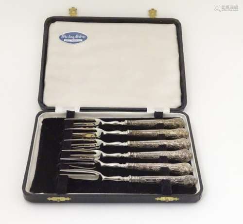 A cast set of 2 tine pastry / cake forks with silver handles hallmarked Sheffield 1971 6