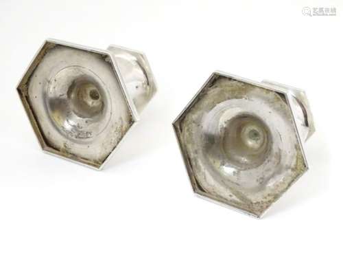 A pair of short candlesticks on hexagonal bases. Hallmarked Sheffield 1914 maker Walker & Hall.