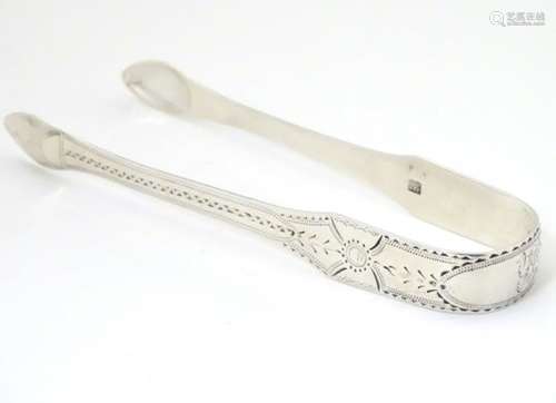 Geo III silver sugar tongs with bright cut decoration hallmarked London 1810 maker Samuel Godbehere,